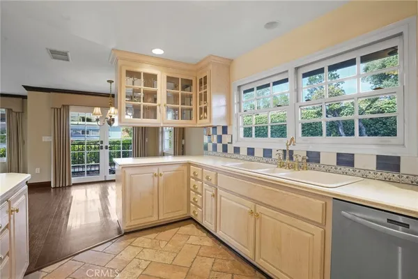 a kitchen with a sink window and cabinets