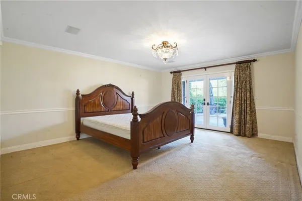 a spacious bedroom with a bed and a window