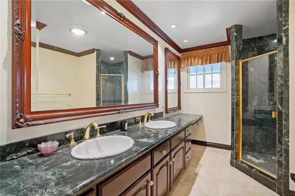 a bathroom with a granite countertop sink mirror and double