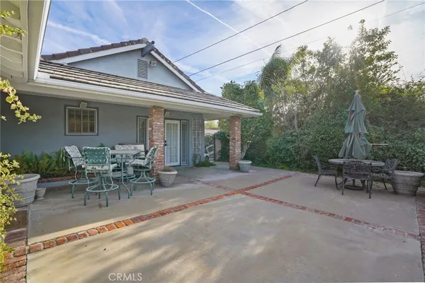 a view of a patio with table and chairs and potted plants