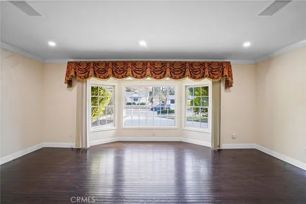 an empty room with wooden floor and front door