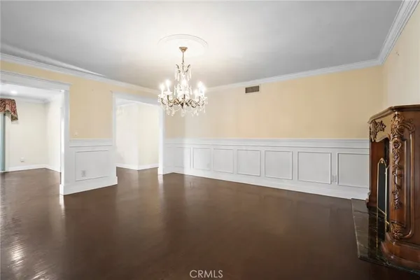 a view of a livingroom with a furniture wooden floor and a chandelier