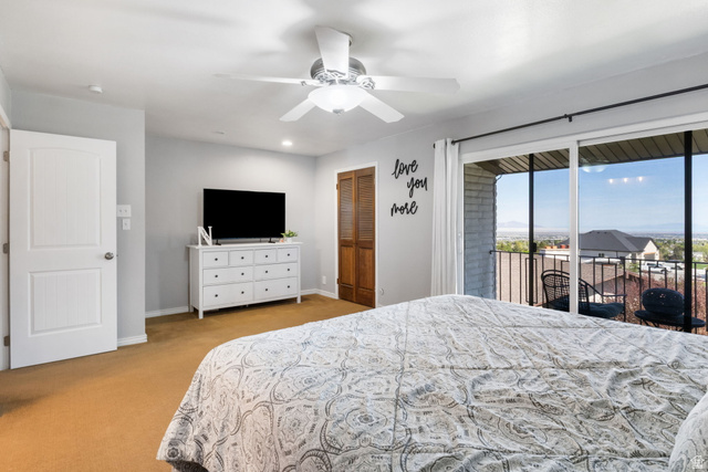 41 Benchmark Village Tooele, UT 84074 - Photo 11 of 26 Bedroom featuring access to exterior, a closet, a ceiling fan, light colored carpet, and recessed lighting