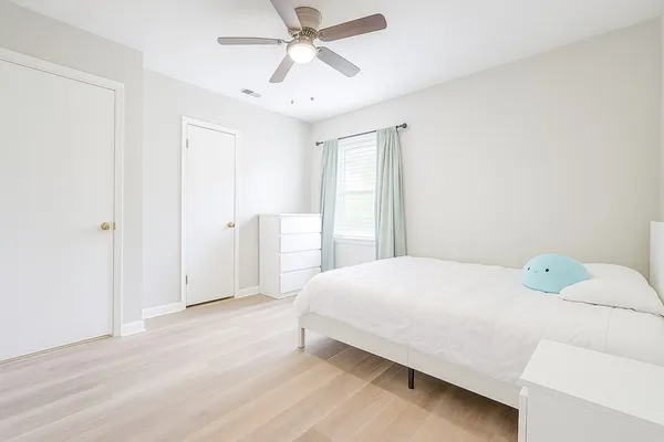 a bedroom with a bed and a chandelier