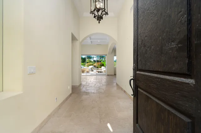 a view of two chairs and table in patio