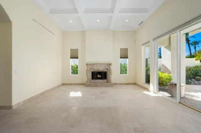 a view of an empty room with wooden floor and a sliding door