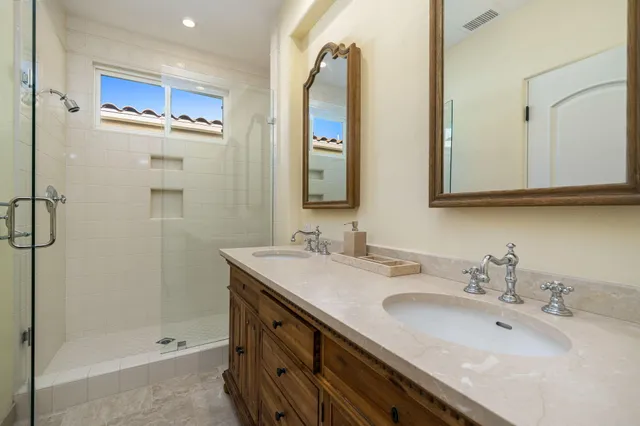 a bathroom with a tub sink and mirror
