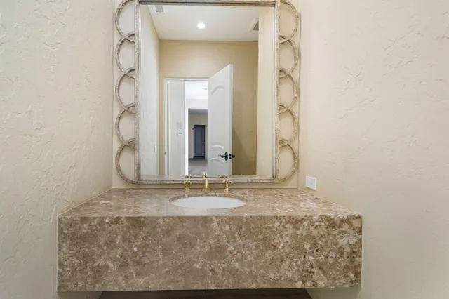 a bathroom with a sink vanity and mirror
