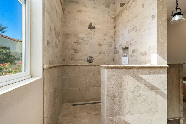 a front view of a house with lots of potted plants