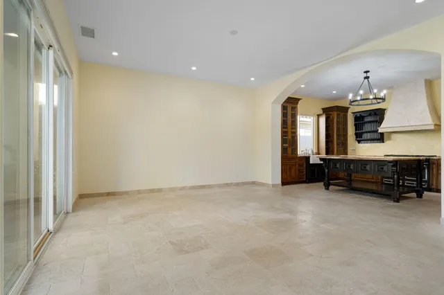 an empty room with fireplace and a bathroom