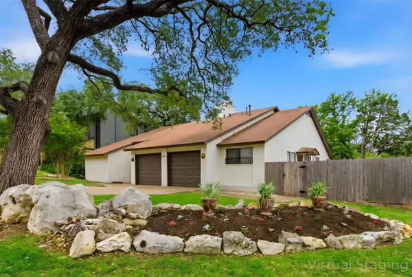 a backyard of a house with table and chairs