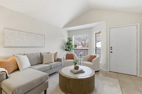 a living room with furniture and a potted plant