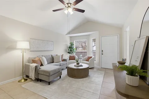 a living room with furniture and a potted plant