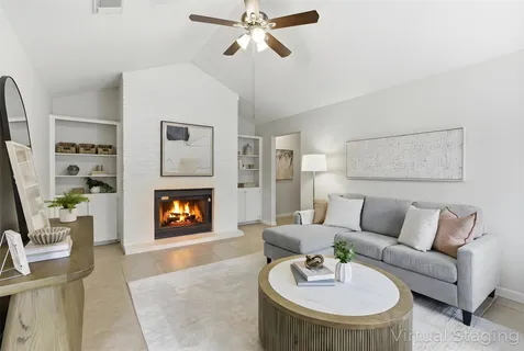 a living room with furniture and a fireplace