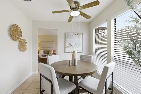 a view of a dining room with furniture and window