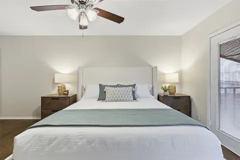 a large bed in a bedroom with a chandelier