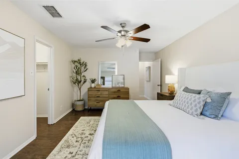 a bedroom with a bed and a chandelier