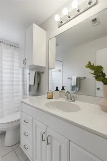 a bathroom with a sink double vanity and a shower