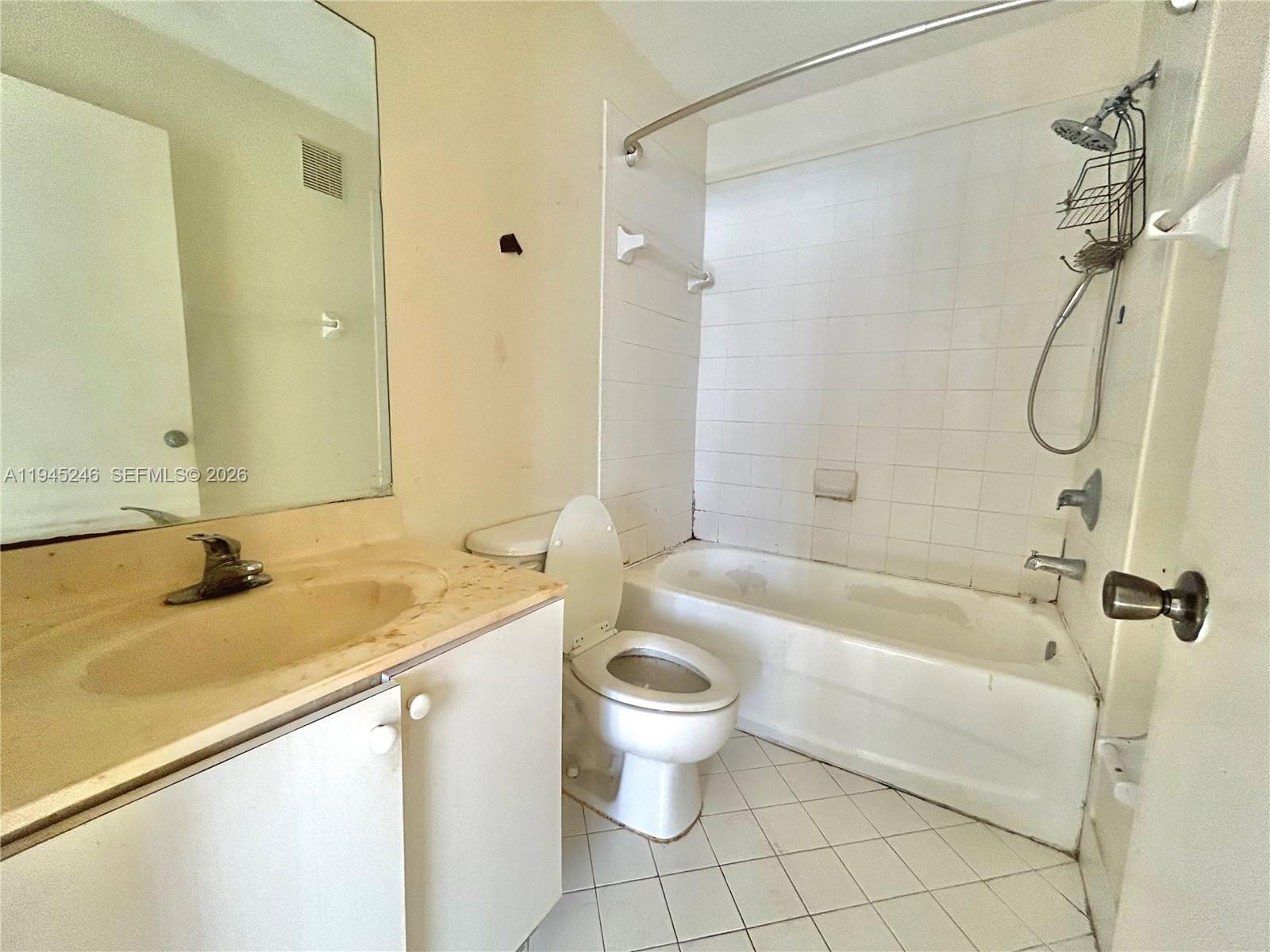 1250 Southeast 29th Street, Unit 20258 Homestead, FL 33035 - Photo 12 of 13 a bathroom with a granite countertop sink a toilet and a bathtub