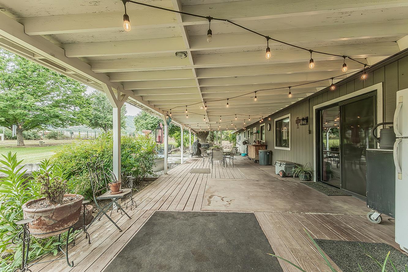 29545 Oak Meadow Road Tollhouse, CA 93667 - Photo 9 of 69 a view of a patio with table and chairs potted plants with floor to ceiling window