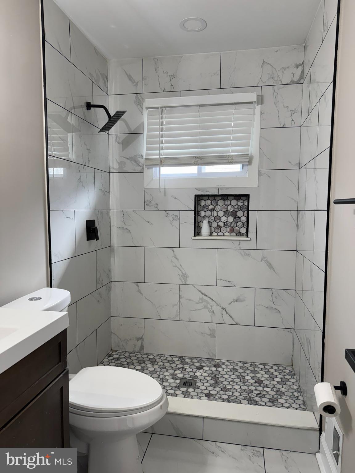 8313 26th Avenue Adelphi, MD 20783 - Photo 12 of 17 a bathroom with a toilet and a shower