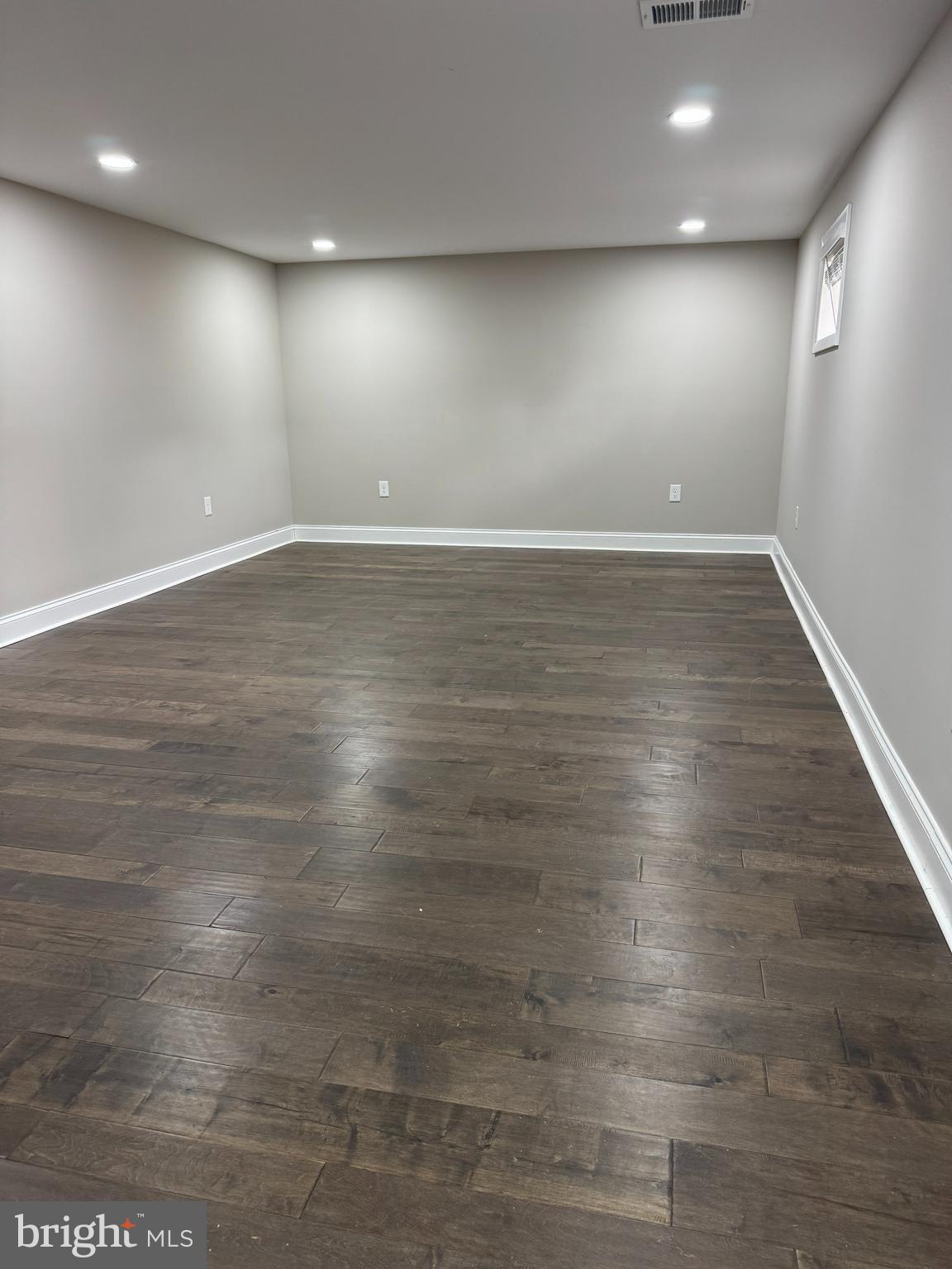 8313 26th Avenue Adelphi, MD 20783 - Photo 13 of 17 an empty room with wooden floor and windows