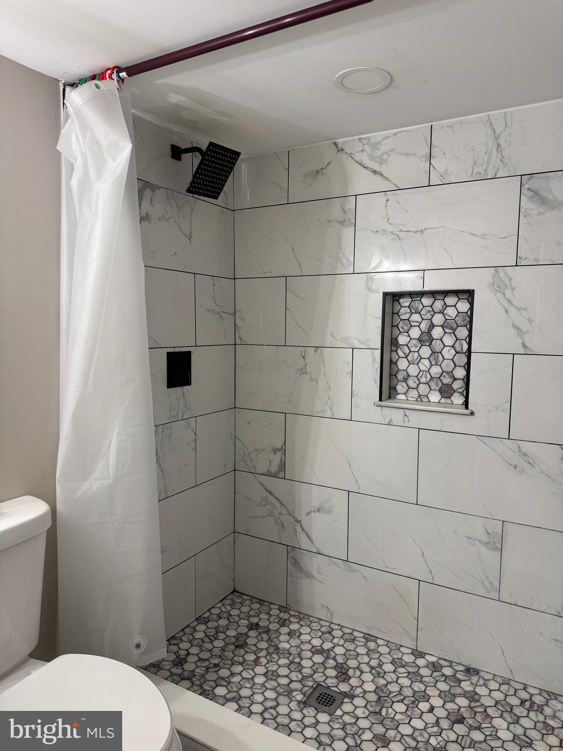 8313 26th Avenue Adelphi, MD 20783 - Photo 15 of 17 a bathroom with a toilet and a shower