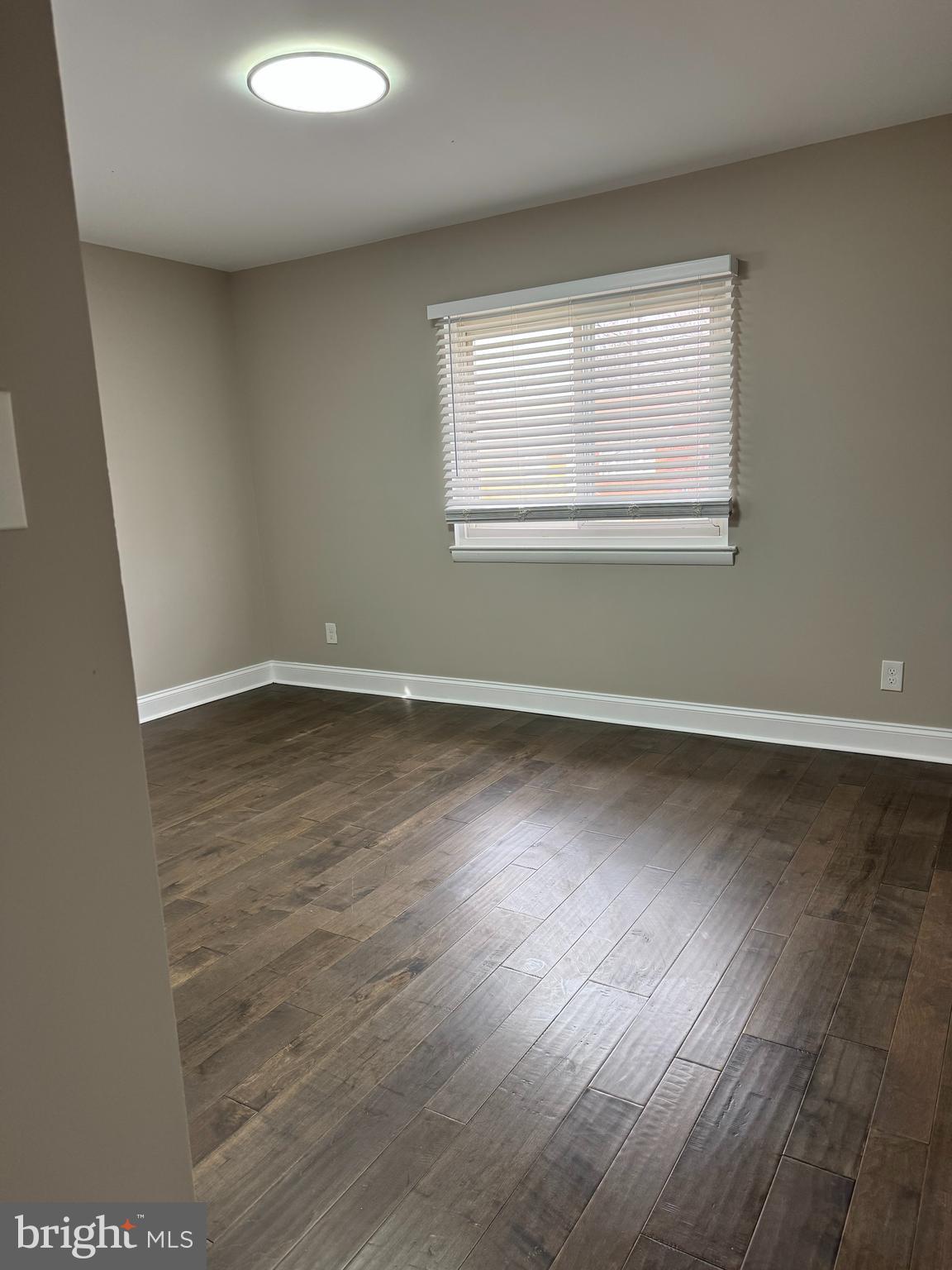 8313 26th Avenue Adelphi, MD 20783 - Photo 4 of 17 an empty room with wooden floor and windows