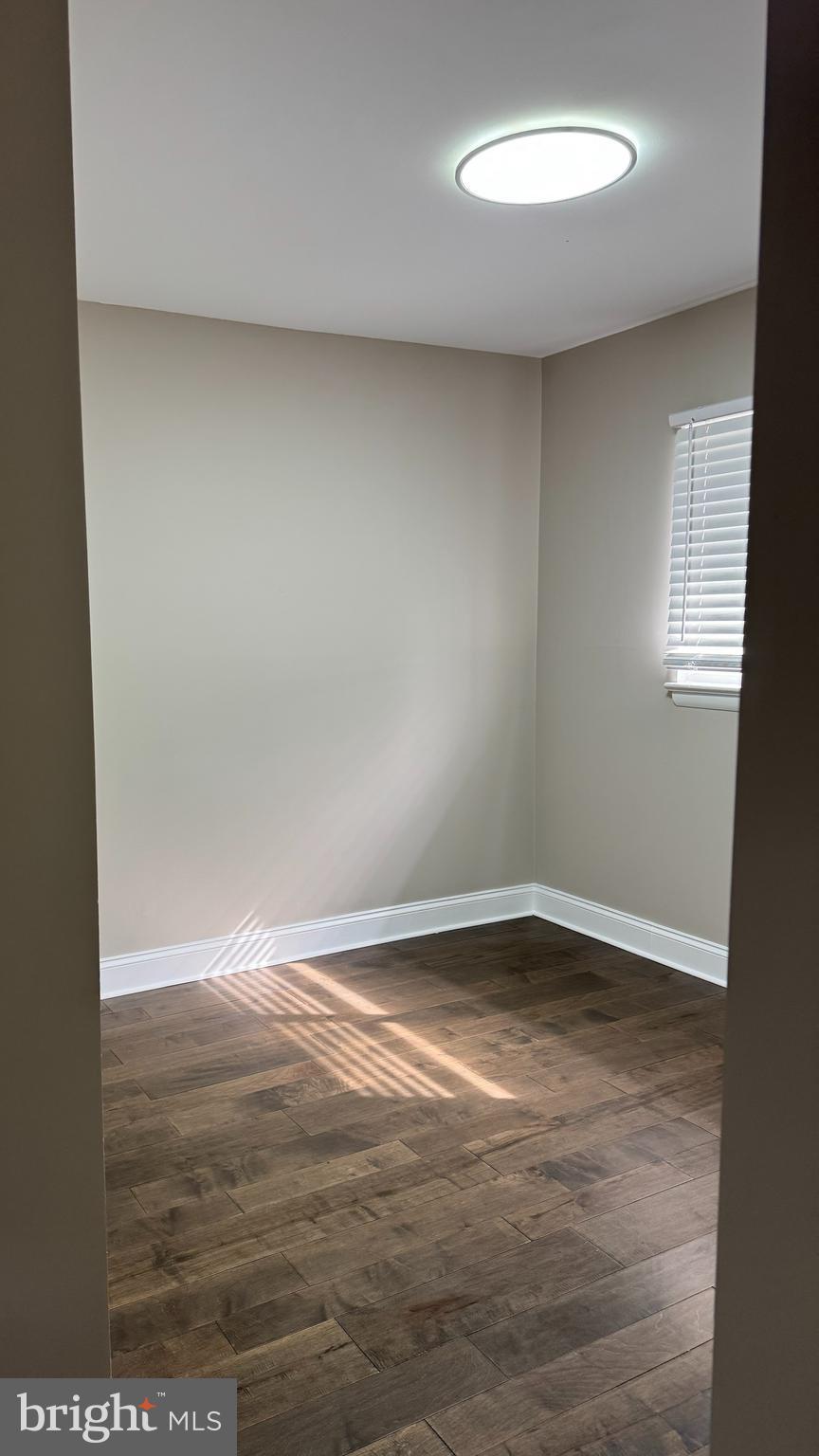8313 26th Avenue Adelphi, MD 20783 - Photo 6 of 17 an empty room with wooden floor and windows
