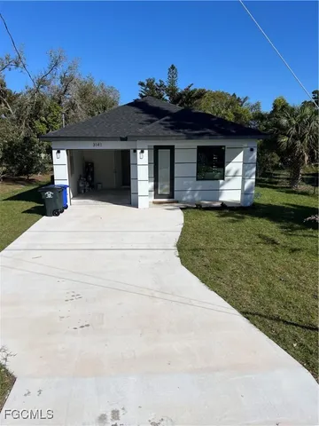 a front view of a house with a garden