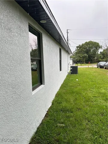 a backyard of a house with table and chairs