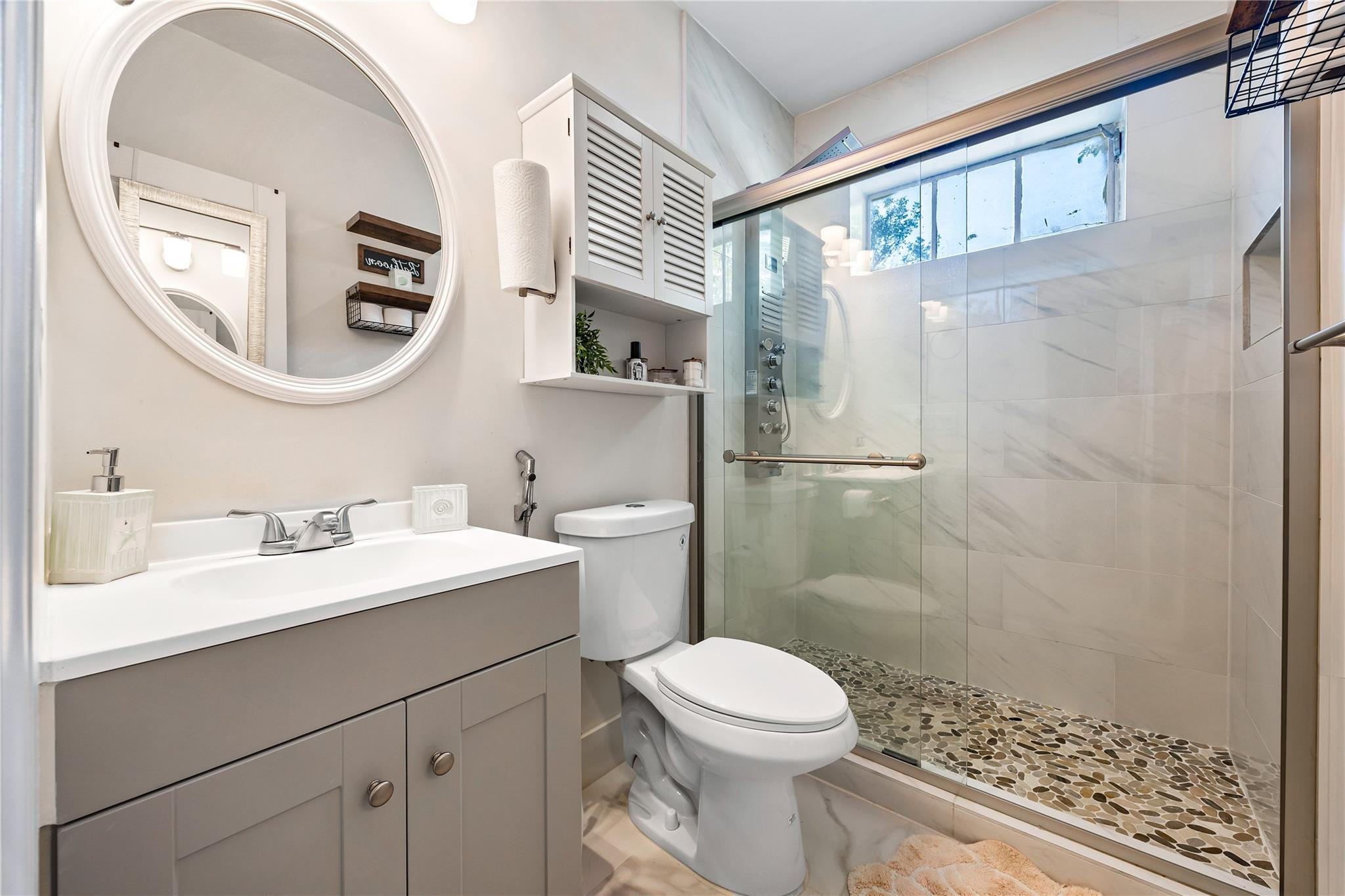 218 Southwest 7th Street Dania Beach, FL 33004 - Photo 17 of 57 a bathroom with a sink a toilet and a mirror