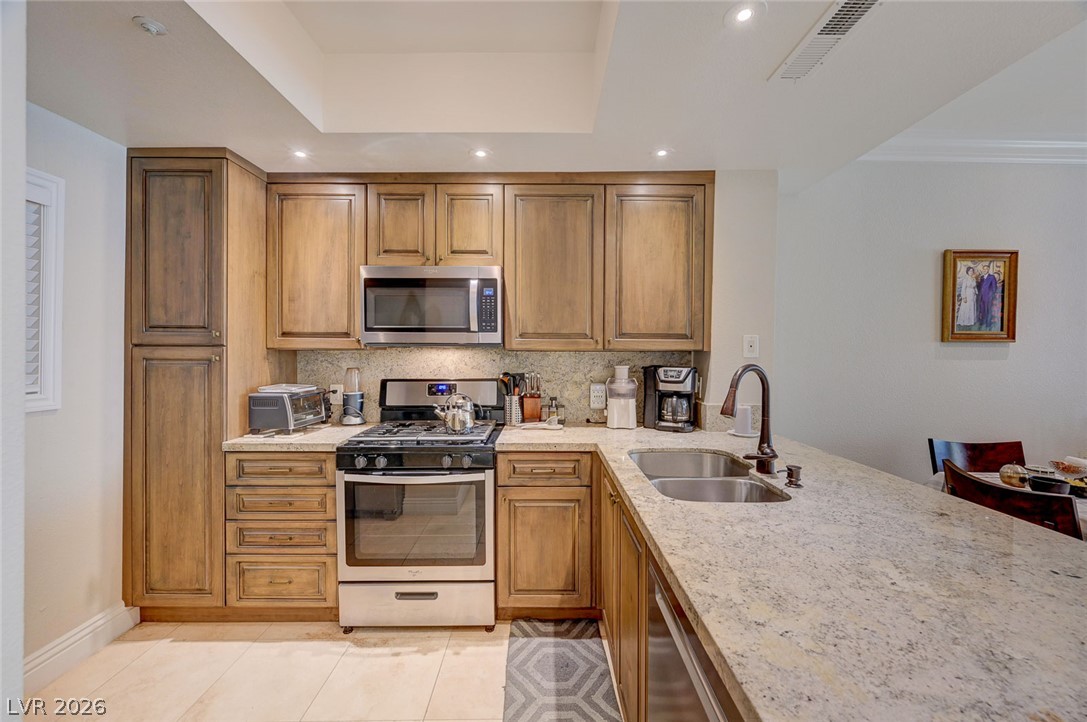 230 East Flamingo Road, Unit 106 Las Vegas, NV 89169 - Photo 6 of 66 Culinary delights await in this well-appointed kitchen, featuring a gas range and gleaming granite countertops.