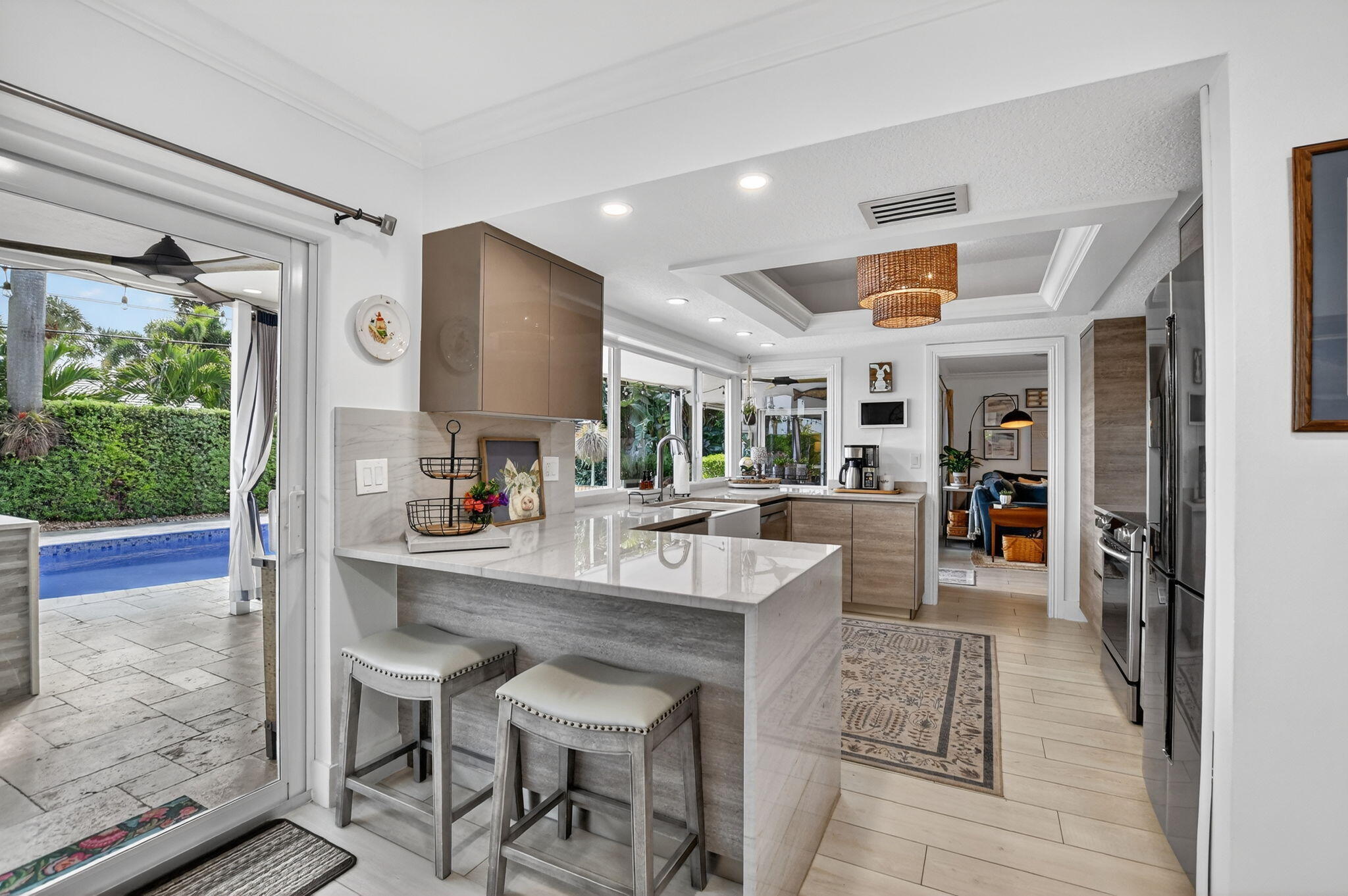 1388 Walnut Terrace Boca Raton, FL 33486 - Photo 20 of 74 a dining hall with stainless steel appliances granite countertop a rug and white cabinets next to a window