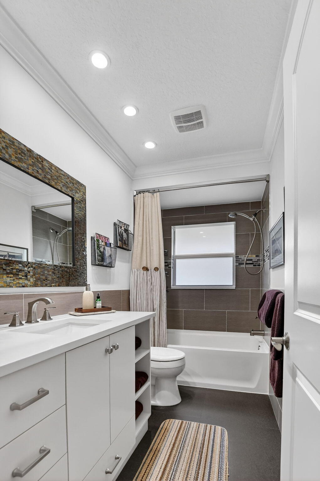 1388 Walnut Terrace Boca Raton, FL 33486 - Photo 39 of 74 a bathroom with a double vanity sink a mirror and a bathtub