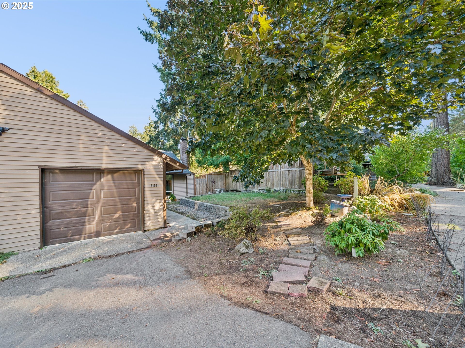 5100 Southwest 153rd Avenue Beaverton, OR 97007 - Photo 15 of 39 a view of a house with a yard and garage