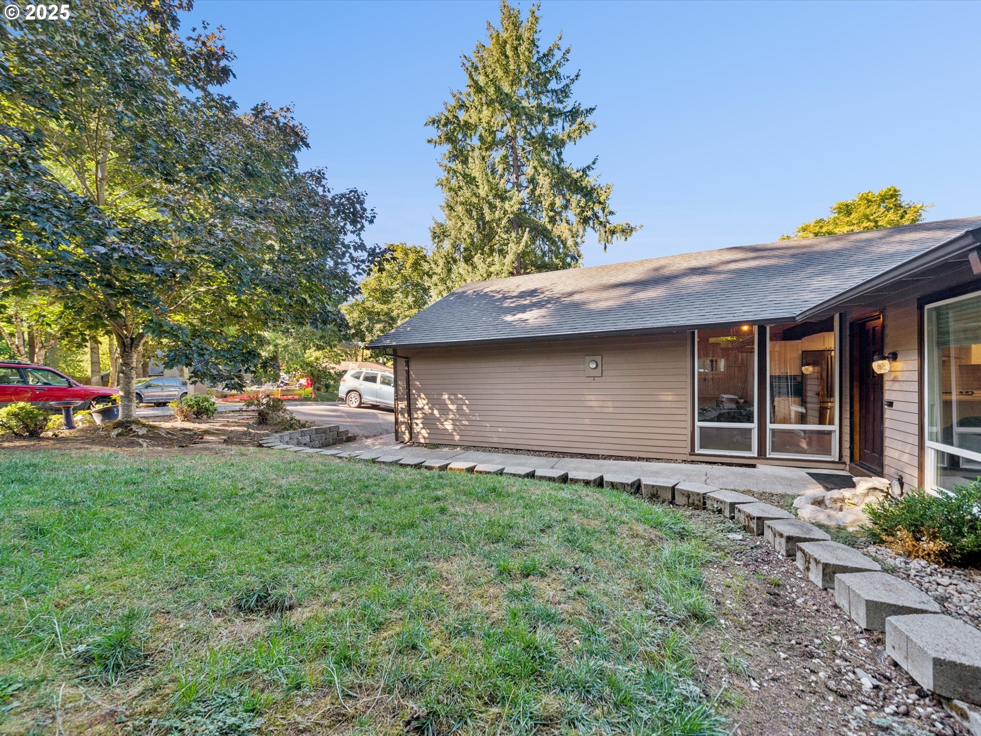 5100 Southwest 153rd Avenue Beaverton, OR 97007 - Photo 16 of 39 a backyard of a house with table and chairs