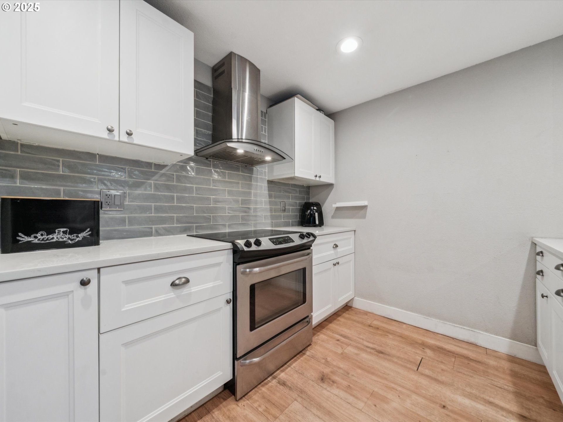 5100 Southwest 153rd Avenue Beaverton, OR 97007 - Photo 24 of 39 a kitchen with cabinets stainless steel appliances and wooden floor