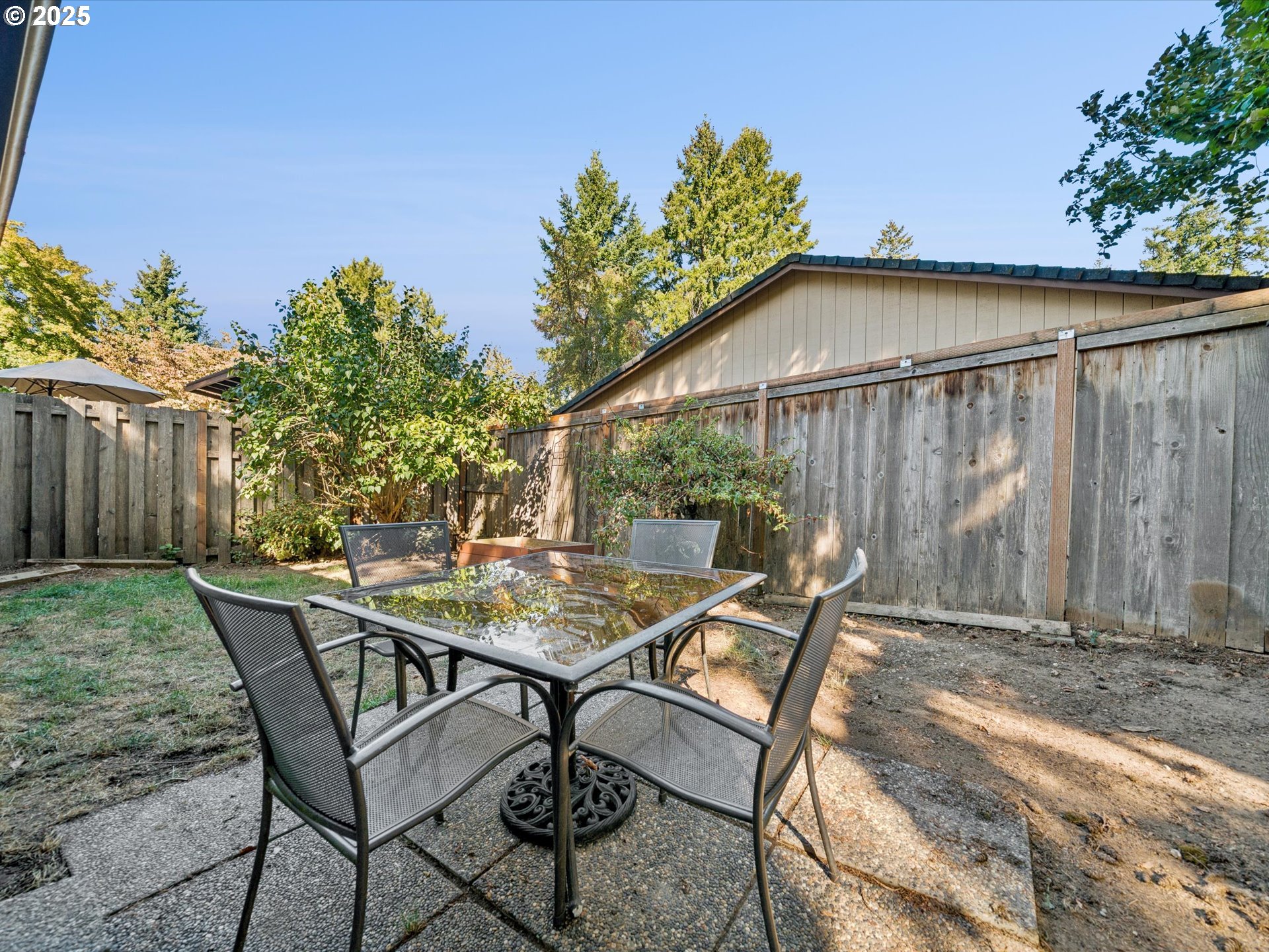 5100 Southwest 153rd Avenue Beaverton, OR 97007 - Photo 36 of 39 a backyard of a house with table and chairs