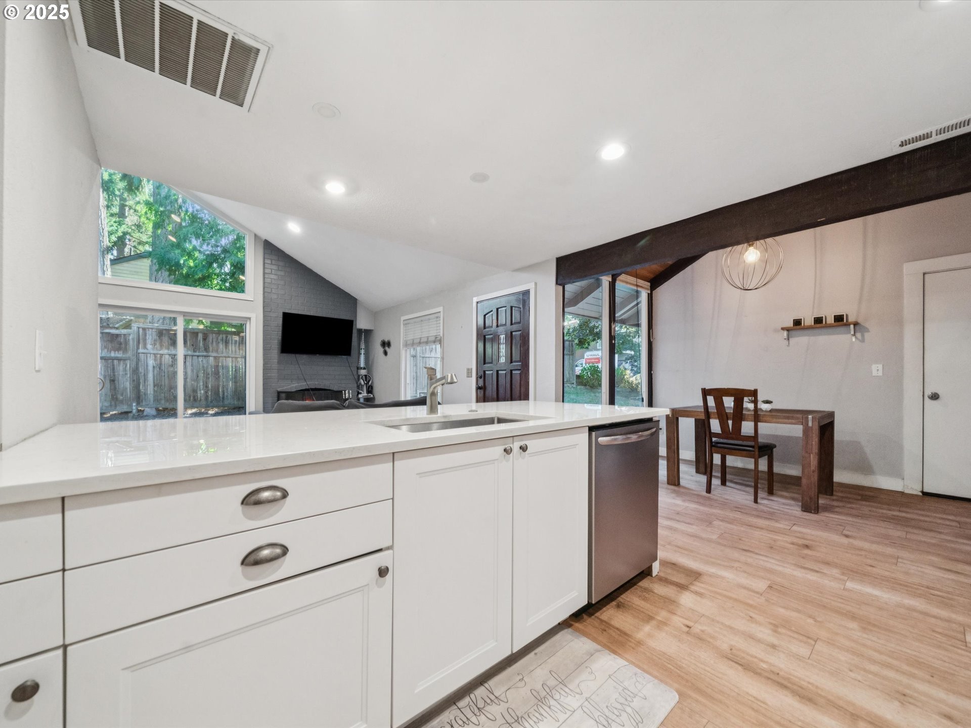 5100 Southwest 153rd Avenue Beaverton, OR 97007 - Photo 4 of 39 a kitchen with white cabinets and wooden floor