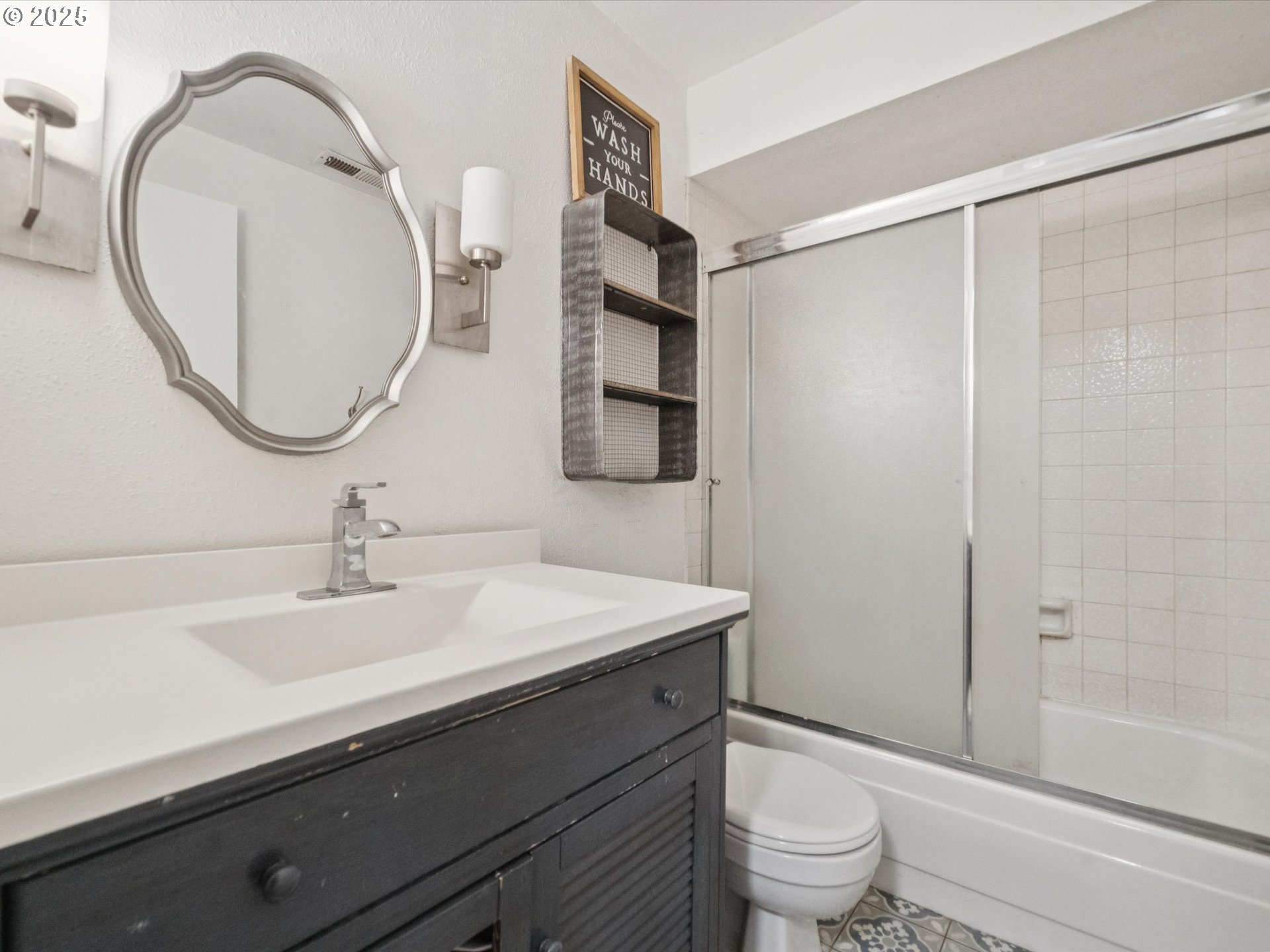 5100 Southwest 153rd Avenue Beaverton, OR 97007 - Photo 9 of 39 a bathroom with a sink a toilet and a mirror