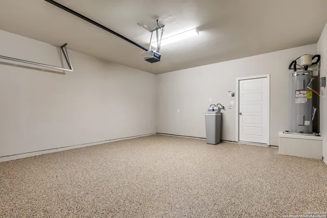an empty room with chandelier and windows