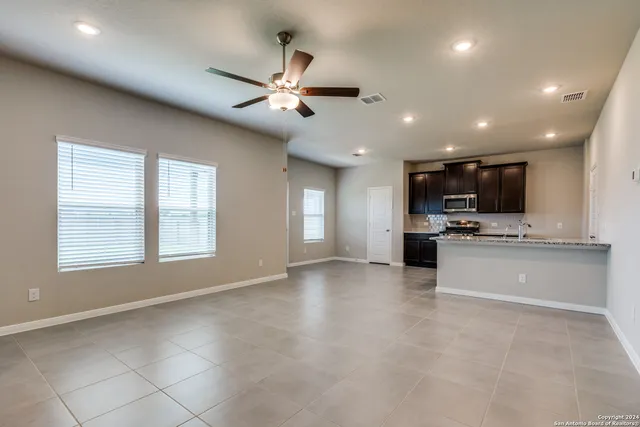 a view of kitchen with microwave and cabinets