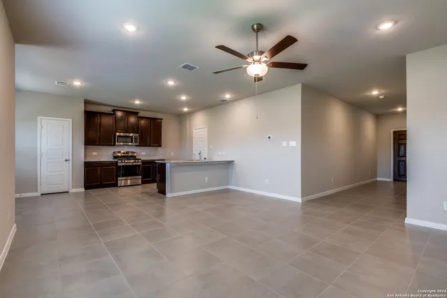 a view of kitchen with refrigerator and microwave