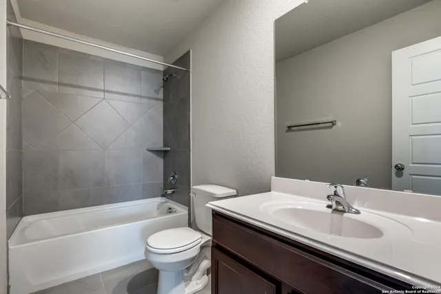 a bathroom with a sink a toilet and a bathtub