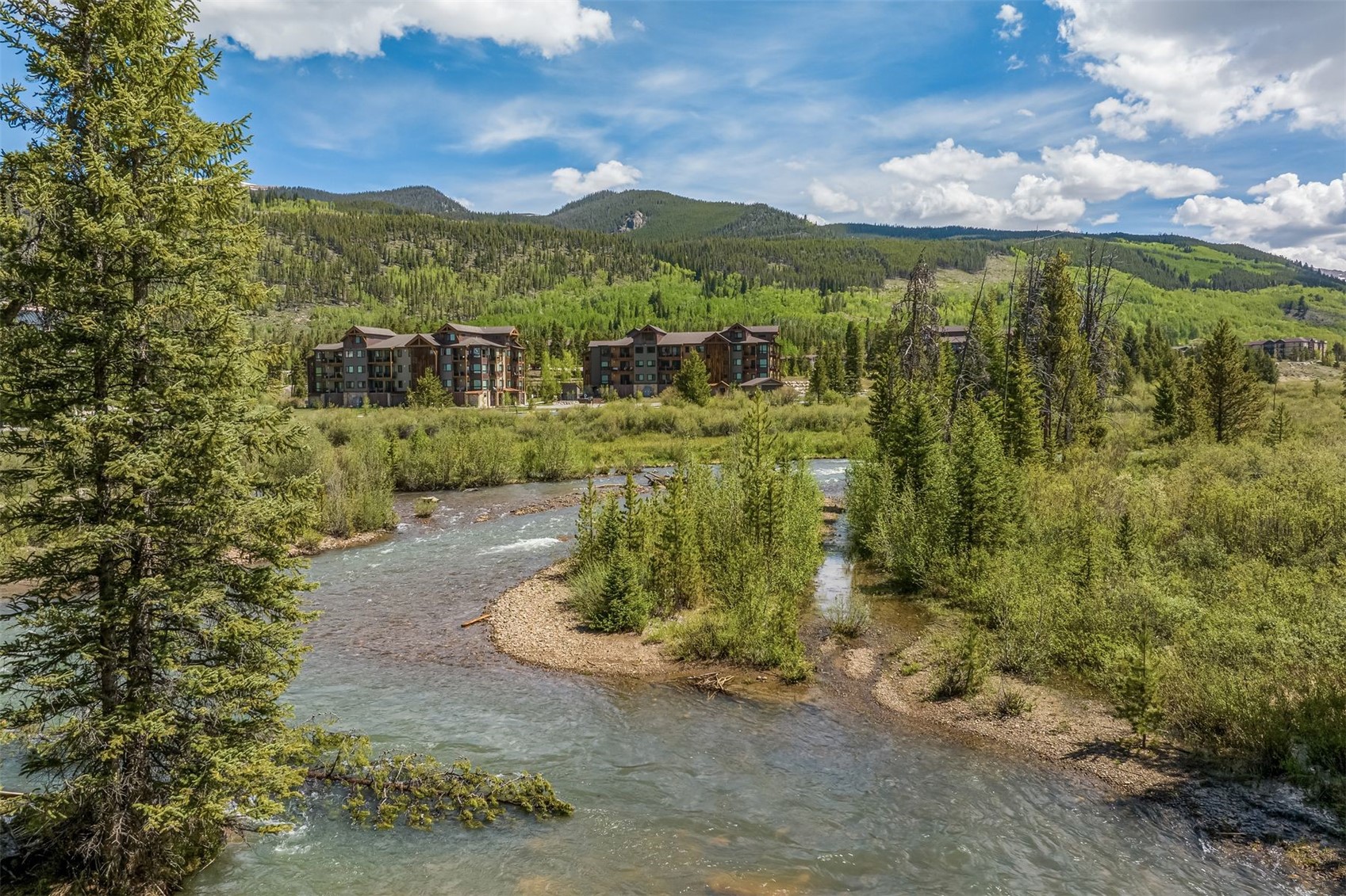 23 Clearwater Way, Unit 102 Keystone, CO 80435 - Photo 7 of 47 View of the Snake River looking back at Clearwater Lofts in the Summer time.