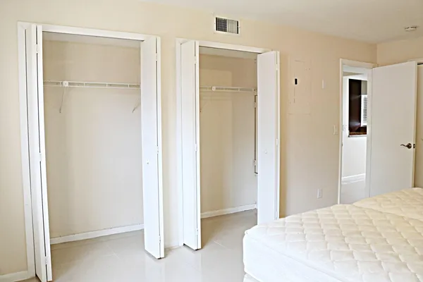 a bedroom with a bed and a closet