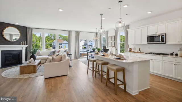 a living room with fireplace furniture and a wooden floor