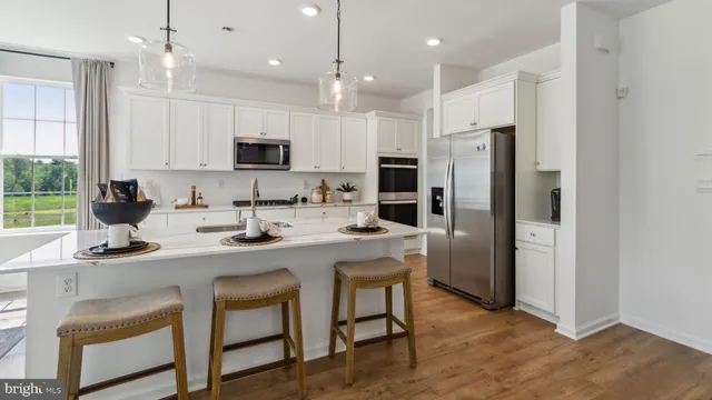 a kitchen with kitchen island appliances cabinets a sink and a counter top space
