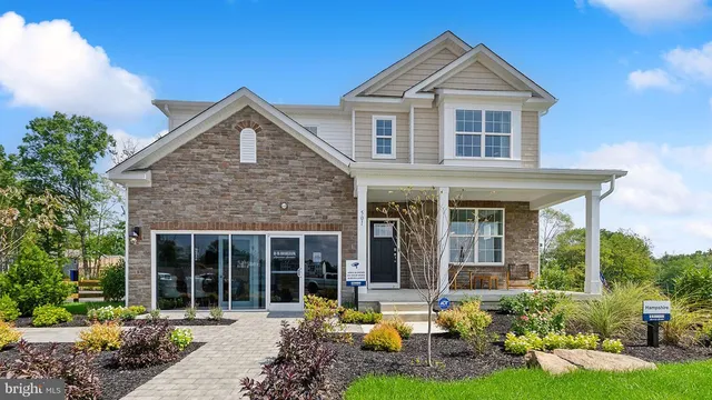 a front view of a house with yard and green space
